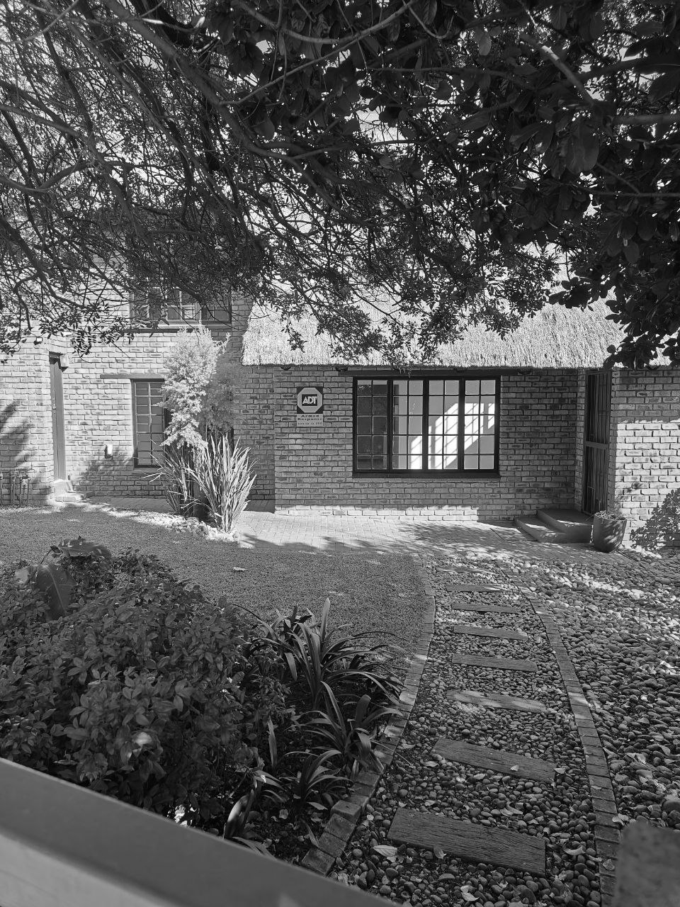 Brick townhouse with a thatched roof and landscaped garden in Pretoria